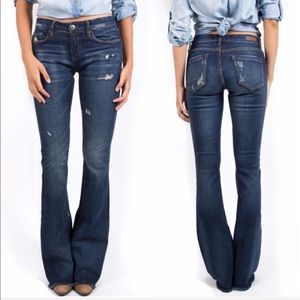 BLANK NYC dark blue distressed flare raw hem jeans